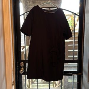 Iike new, black shift dress with left waist bow accent. From Paris.